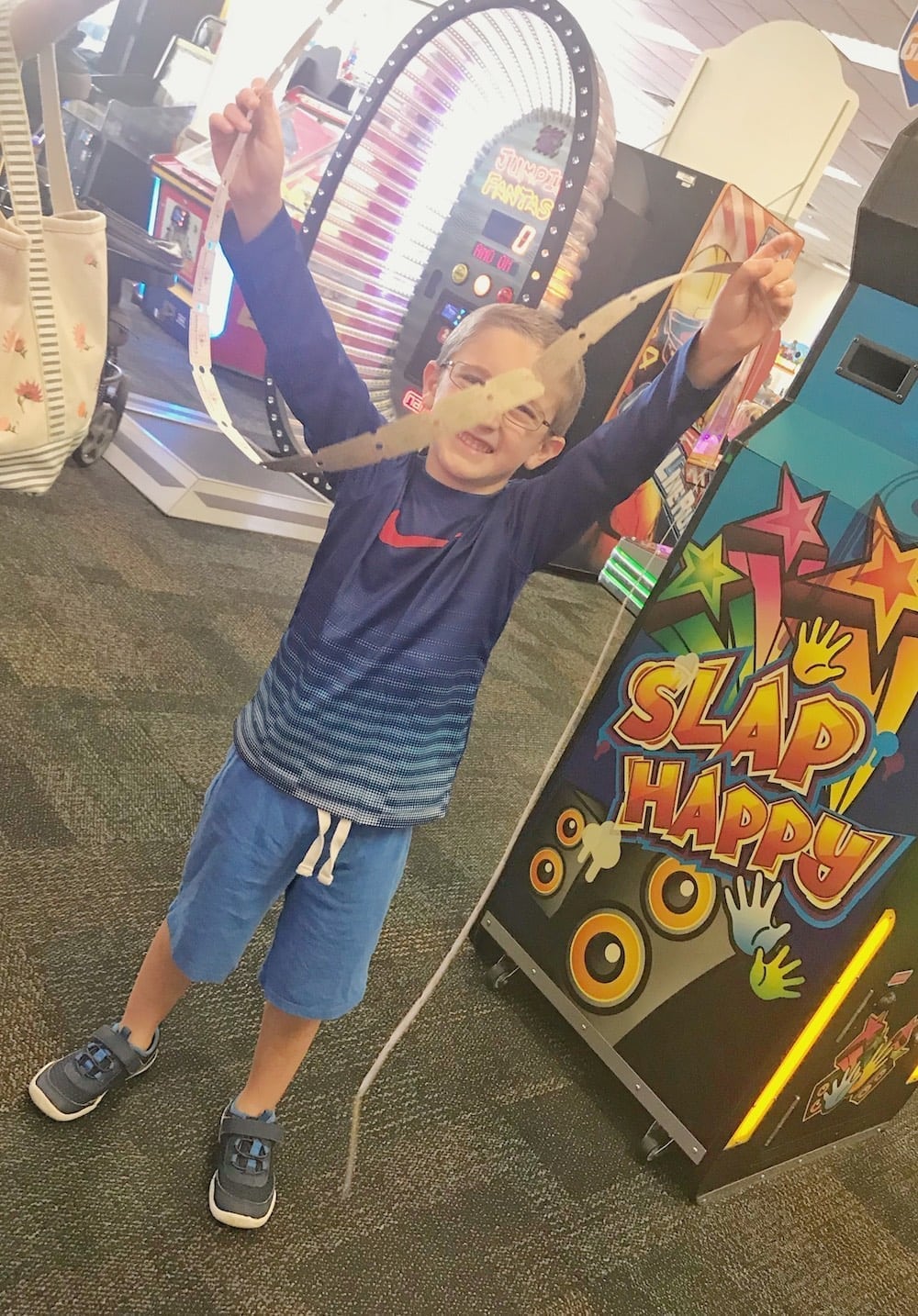 Chuck E Cheese's happy boy with tickets